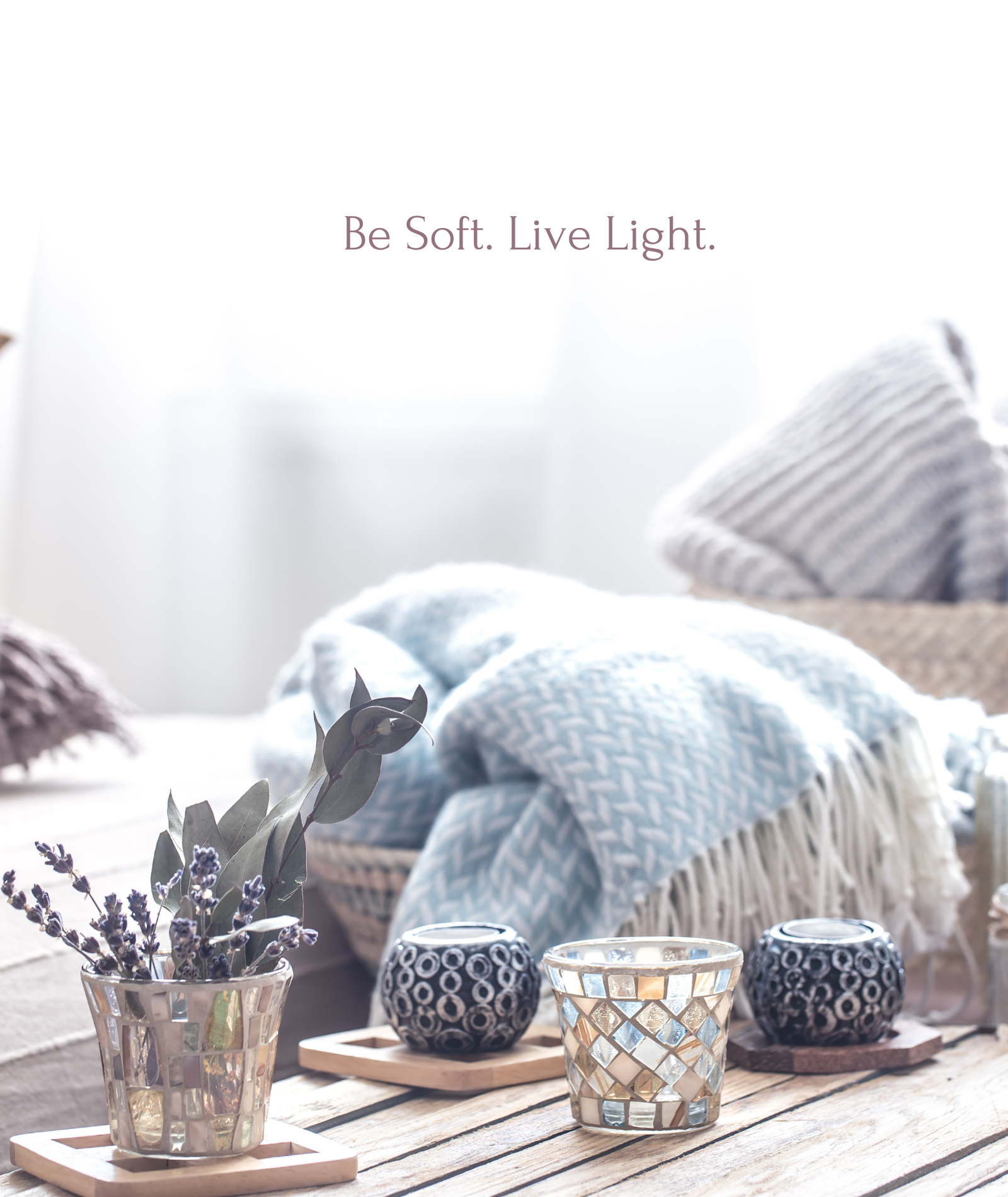 Cozy minimal living space with soft blankets, lavender bouquet, candles, and natural textures — embodying the essence of soft living and emotional minimalism