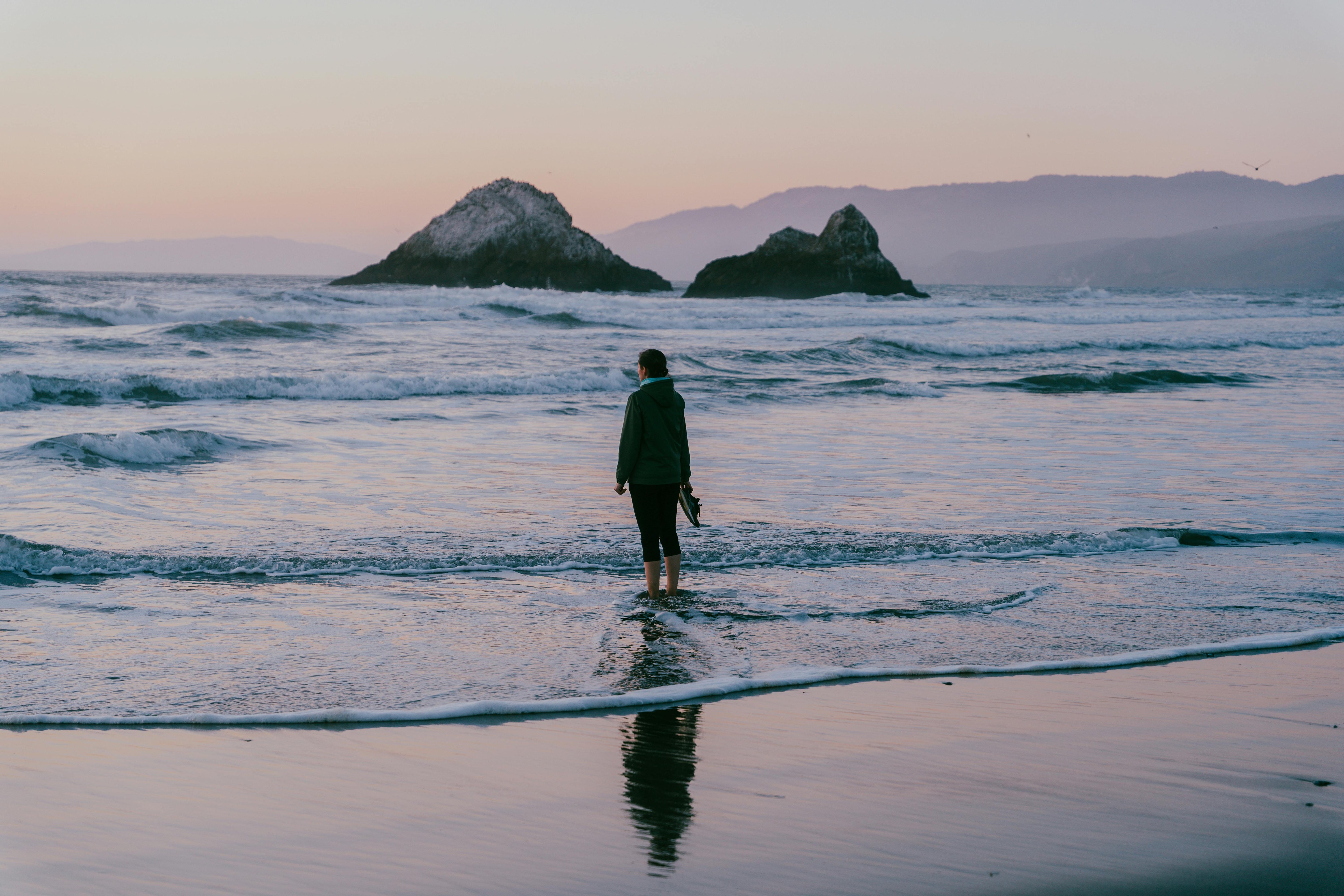 Person walking into soft ocean waves at sunset – a visual metaphor for release and reflection | Align Prompt by Be Soft