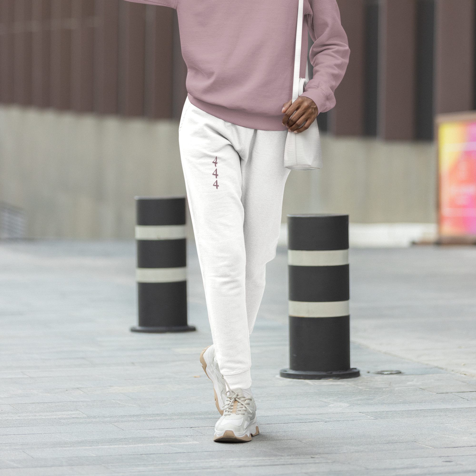 White joggers in Halo tone with vertical 444 angel number in mauve, symbolizing protection, grounded energy, and soft alignment.