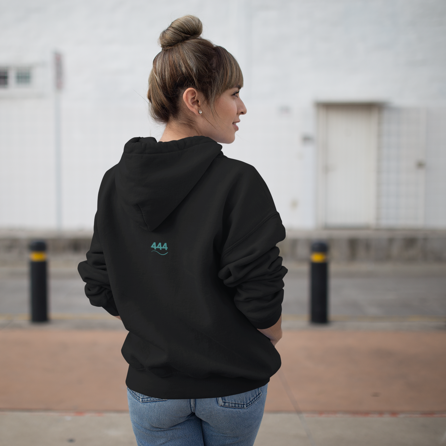 Women in Black hoodie with teal 444 embroidery and Hz 432